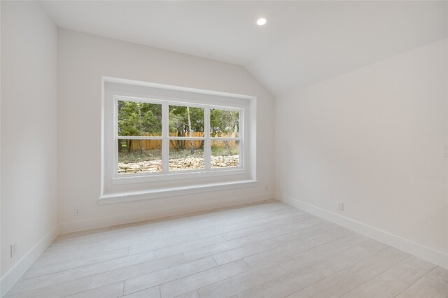 unfurnished room featuring recessed lighting, baseboards, lofted ceiling, and light wood-style flooring