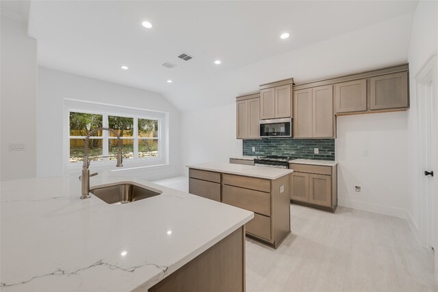 kitchen featuring a sink, stainless steel appliances, tasteful backsplash, and visible vents