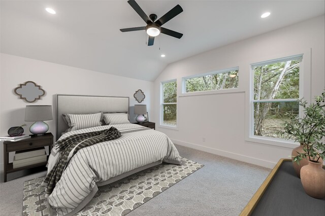 bedroom with lofted ceiling, multiple windows, light colored carpet, and baseboards