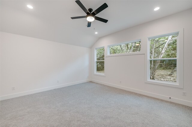 unfurnished room with recessed lighting, baseboards, light carpet, and vaulted ceiling