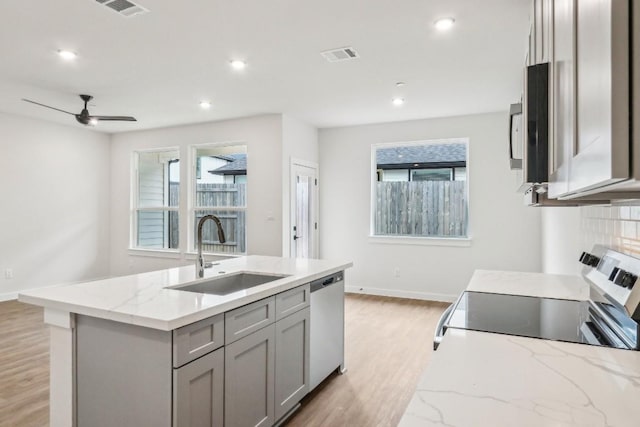 kitchen with visible vents, dishwasher, gray cabinets, electric stove, and a sink