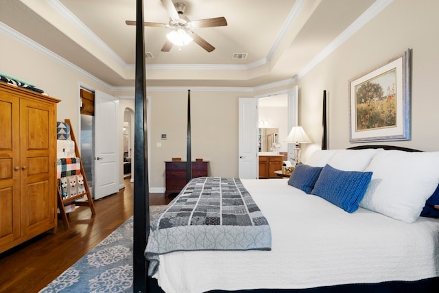 bedroom featuring visible vents, crown molding, arched walkways, dark wood-style floors, and a raised ceiling