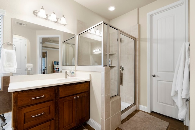 full bathroom featuring tile patterned flooring, visible vents, a stall shower, and vanity