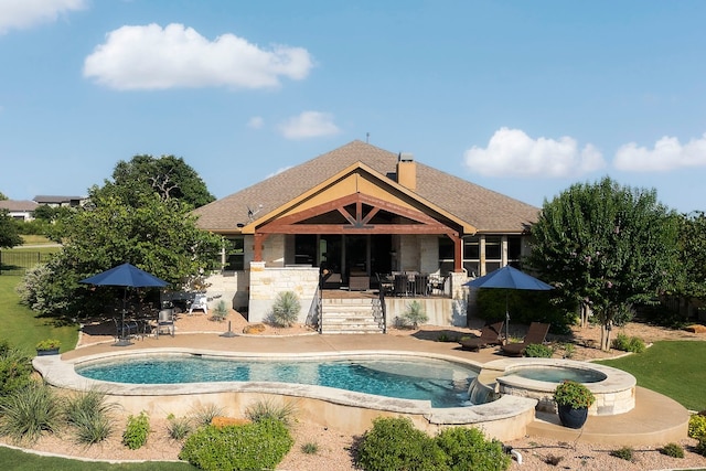 view of swimming pool with a pool with connected hot tub and a patio area