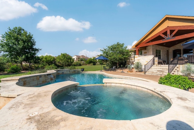 view of swimming pool featuring stairs, an in ground hot tub, and a fenced in pool