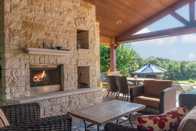 view of patio featuring an outdoor living space with a fireplace