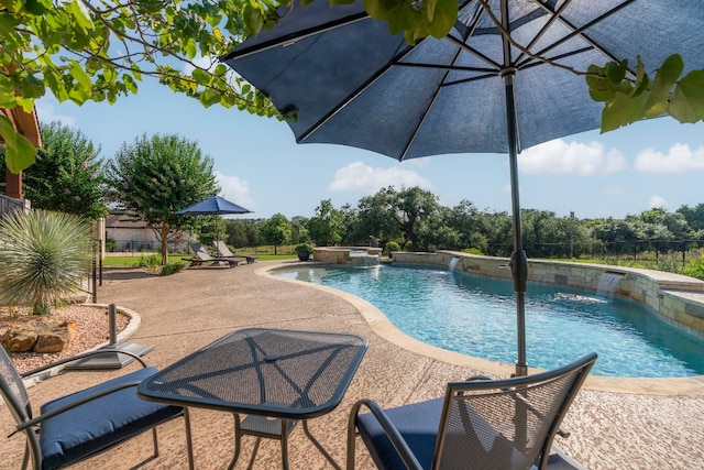 view of swimming pool with a patio area, fence, and a pool with connected hot tub