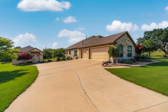 view of front of home with stone siding, an attached garage, driveway, and a front lawn