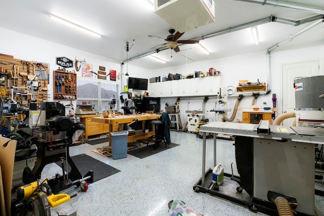 garage with a workshop area and a ceiling fan