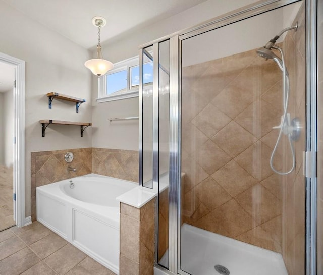 full bath with tile patterned flooring, a stall shower, and a garden tub