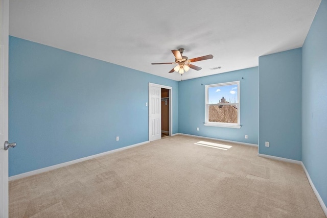 unfurnished bedroom featuring visible vents, baseboards, carpet flooring, a closet, and a ceiling fan