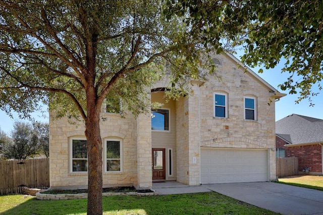 view of front of house featuring concrete driveway, an attached garage, fence, and a front yard