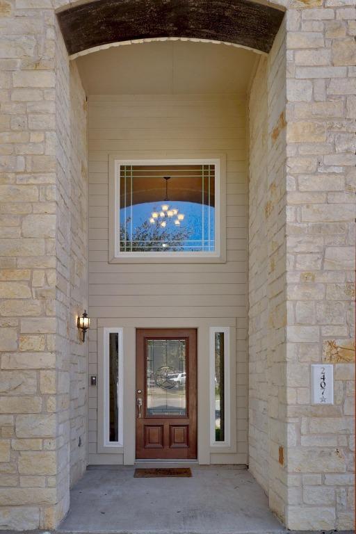 property entrance with stone siding