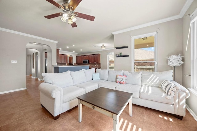 living area with crown molding, light tile patterned flooring, and arched walkways