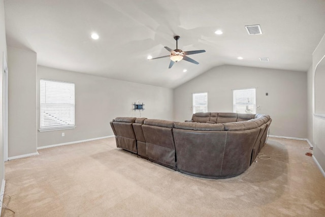 living room with visible vents, baseboards, ceiling fan, light colored carpet, and lofted ceiling