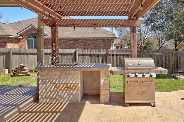 view of patio featuring grilling area and fence