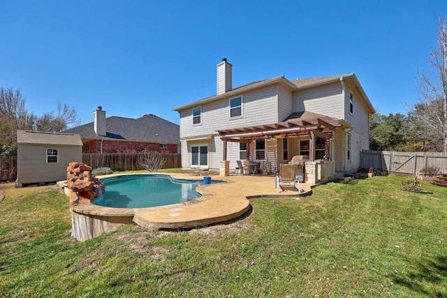 back of property with an outbuilding, a fenced backyard, a pergola, a chimney, and a lawn