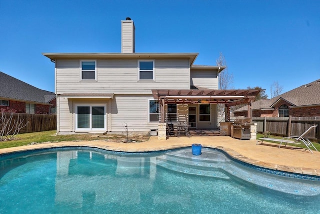 back of property with a pergola, a patio, a fenced backyard, a fenced in pool, and a chimney