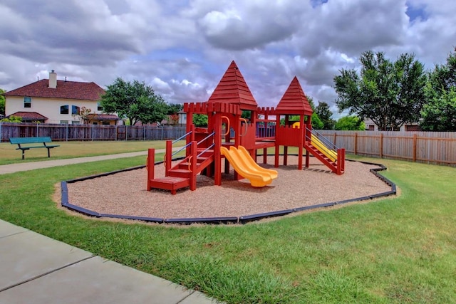 view of playground with a yard and fence