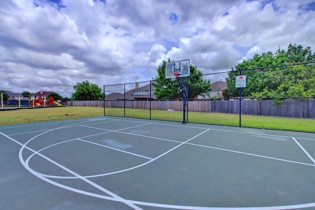 view of sport court featuring playground community, a lawn, community basketball court, and fence