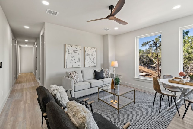 living area with recessed lighting, visible vents, baseboards, and light wood-style floors