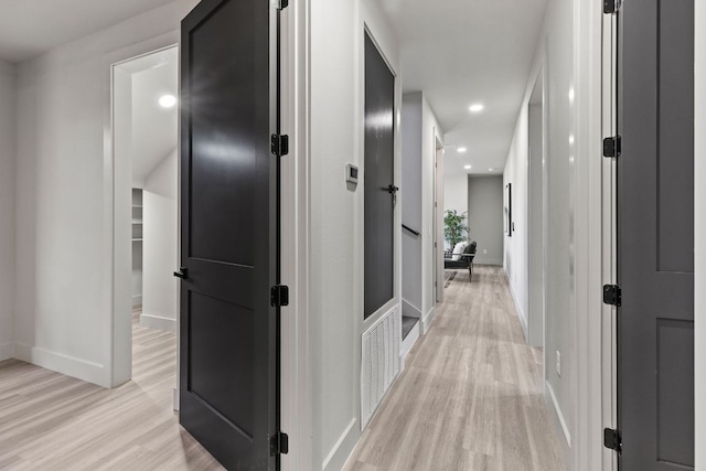 corridor featuring recessed lighting, visible vents, baseboards, and light wood-style flooring