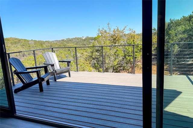 wooden deck with a view of trees