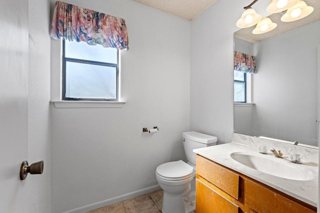 bathroom with tile patterned floors, baseboards, toilet, and vanity