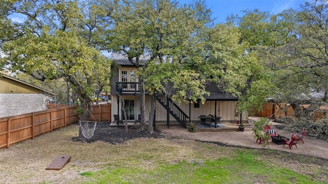 4703 White Elm Ct, Austin, TX 78749 - rear view of house featuring a fire pit, stairs, a deck, a fenced backyard, and a patio