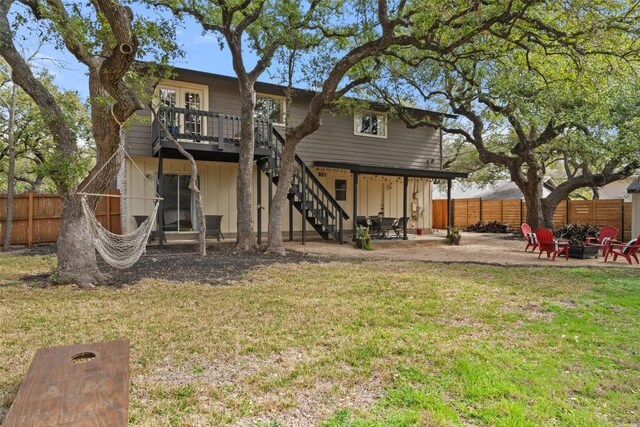 4703 White Elm Ct, Austin, TX 78749 - back of property with an outdoor fire pit, a fenced backyard, stairway, and a patio area