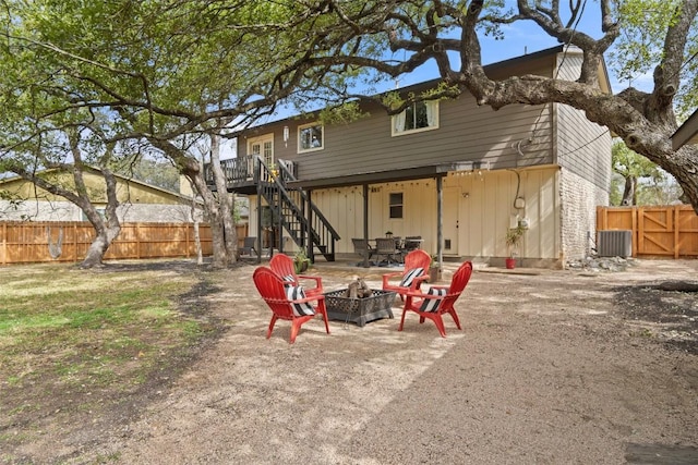 back of house featuring a patio, cooling unit, fence, an outdoor fire pit, and stairs