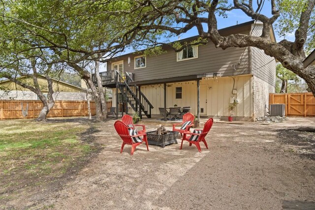 4703 White Elm Ct, Austin, TX 78749 - rear view of house with a fire pit, stairway, a fenced backyard, board and batten siding, and a patio