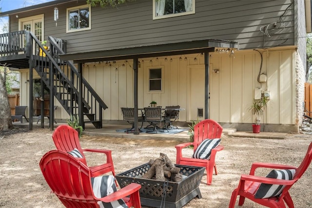 view of patio with stairs, a fire pit, and a wooden deck