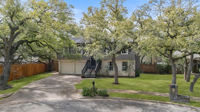 view of front facade with a front lawn, fence, concrete driveway, a garage, and brick siding