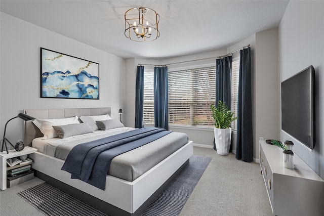 bedroom with a chandelier, light colored carpet, and baseboards