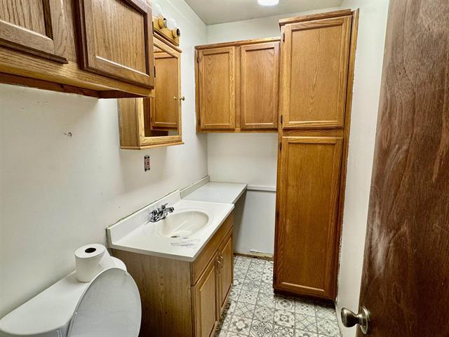 bathroom with tile patterned floors and vanity