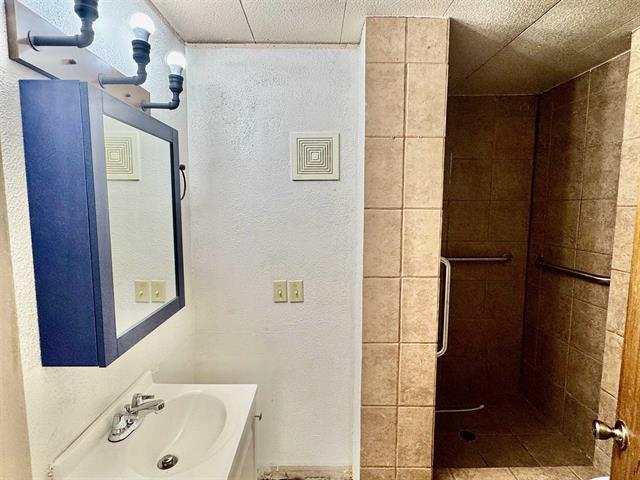 full bath featuring a shower stall and vanity