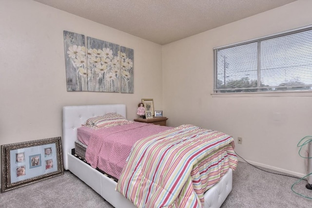 bedroom featuring carpet floors and a textured ceiling