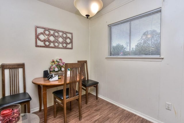 dining room featuring wood finished floors and baseboards