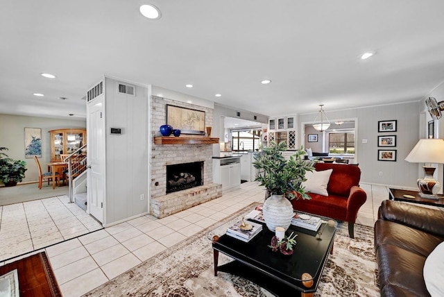 living area featuring recessed lighting, light tile patterned floors, a fireplace, and visible vents