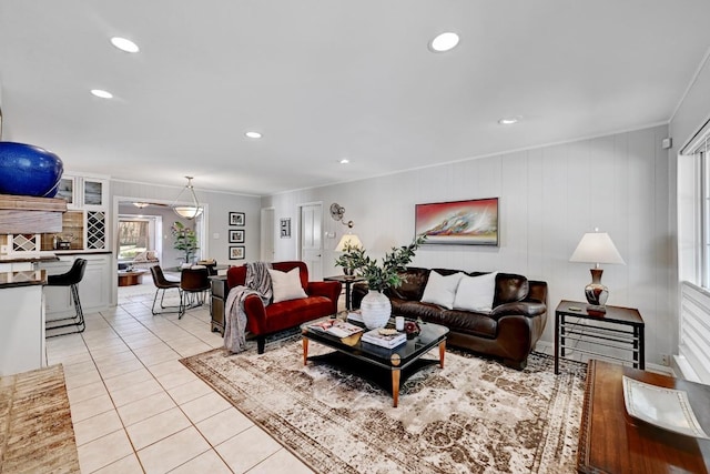 living room featuring light tile patterned floors, recessed lighting, and crown molding