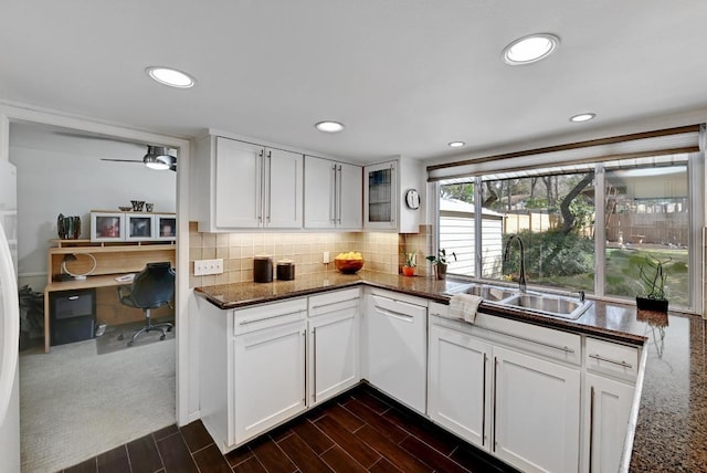 kitchen with a sink, white appliances, backsplash, and wood finish floors