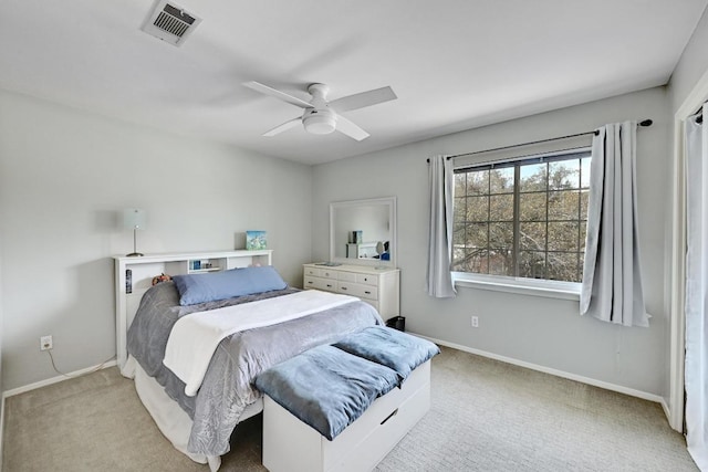 carpeted bedroom with visible vents, ceiling fan, and baseboards