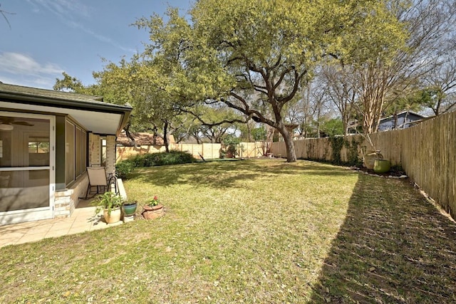 view of yard with a fenced backyard and a sunroom