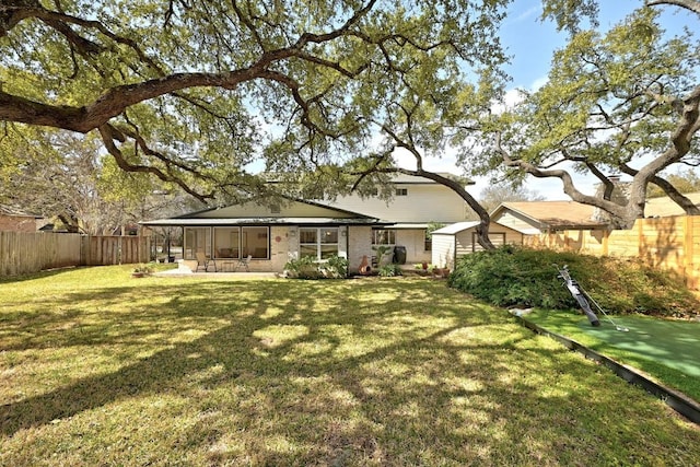 view of yard featuring a fenced backyard and a sunroom