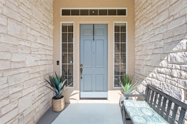 property entrance with stucco siding