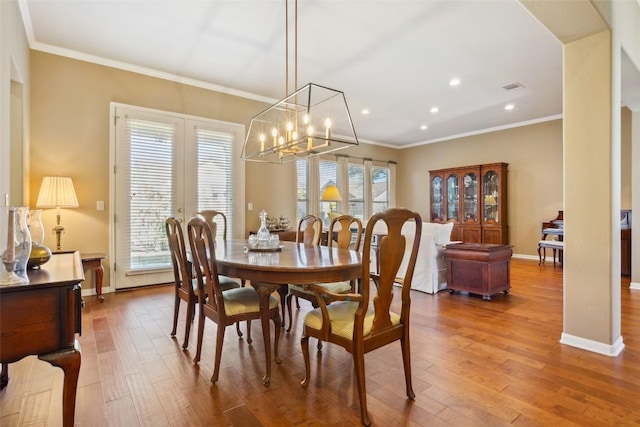 dining space with visible vents, crown molding, baseboards, recessed lighting, and wood finished floors