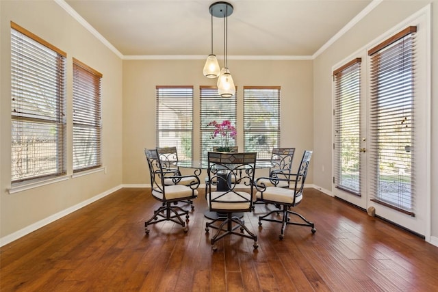 dining space with a healthy amount of sunlight, crown molding, and wood finished floors