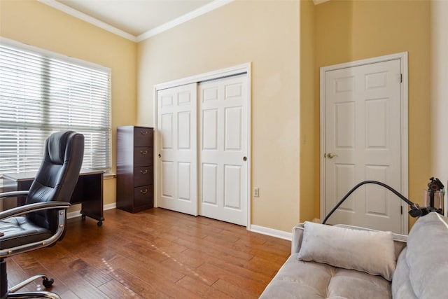 home office featuring baseboards, wood finished floors, and crown molding