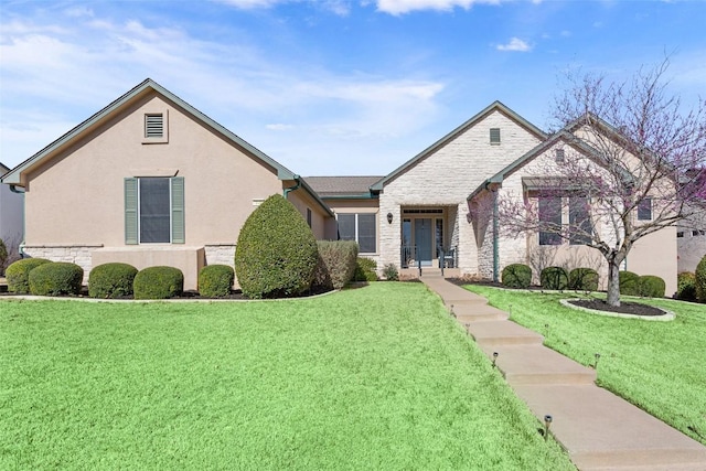 view of front of home with stucco siding, stone siding, and a front yard